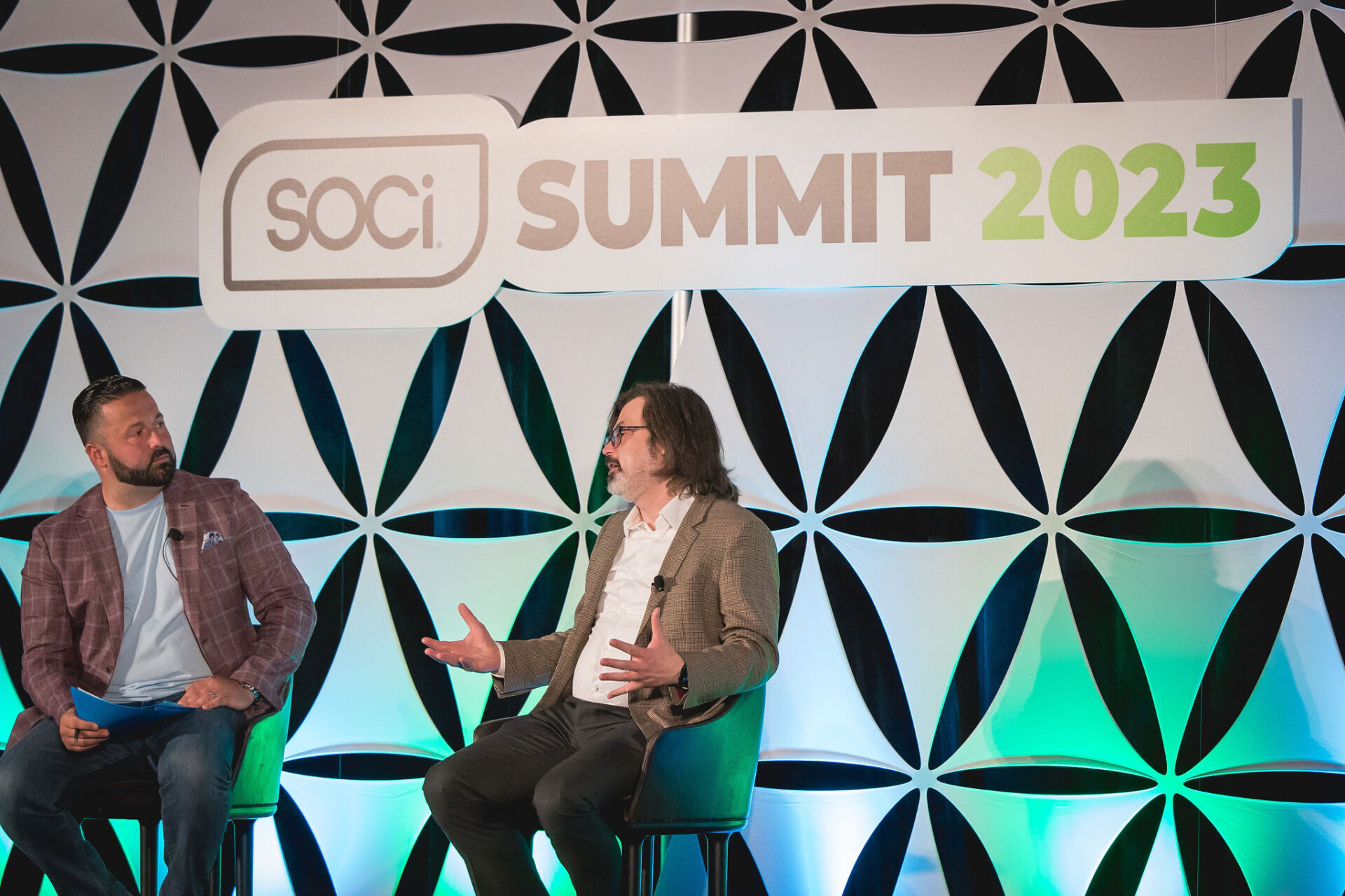 An image of SOCi's Bobby Ferla and Walmart's Brian Moore speaking together on stage at SOCi Summit