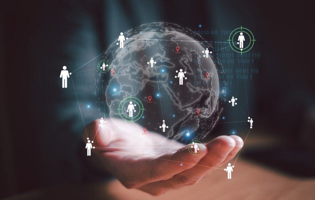 image of open hand holding illustration of globe with a network of people