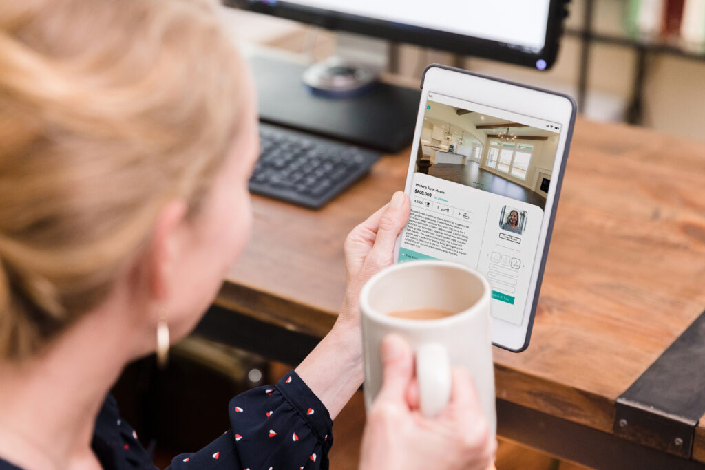 woman reviewing real estate listings on her tablet.